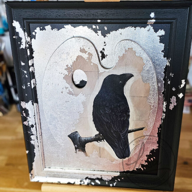 Original Painting of a Crow on an Artist palette set with Silver Leaf in a Black Frame by Liisa Clark