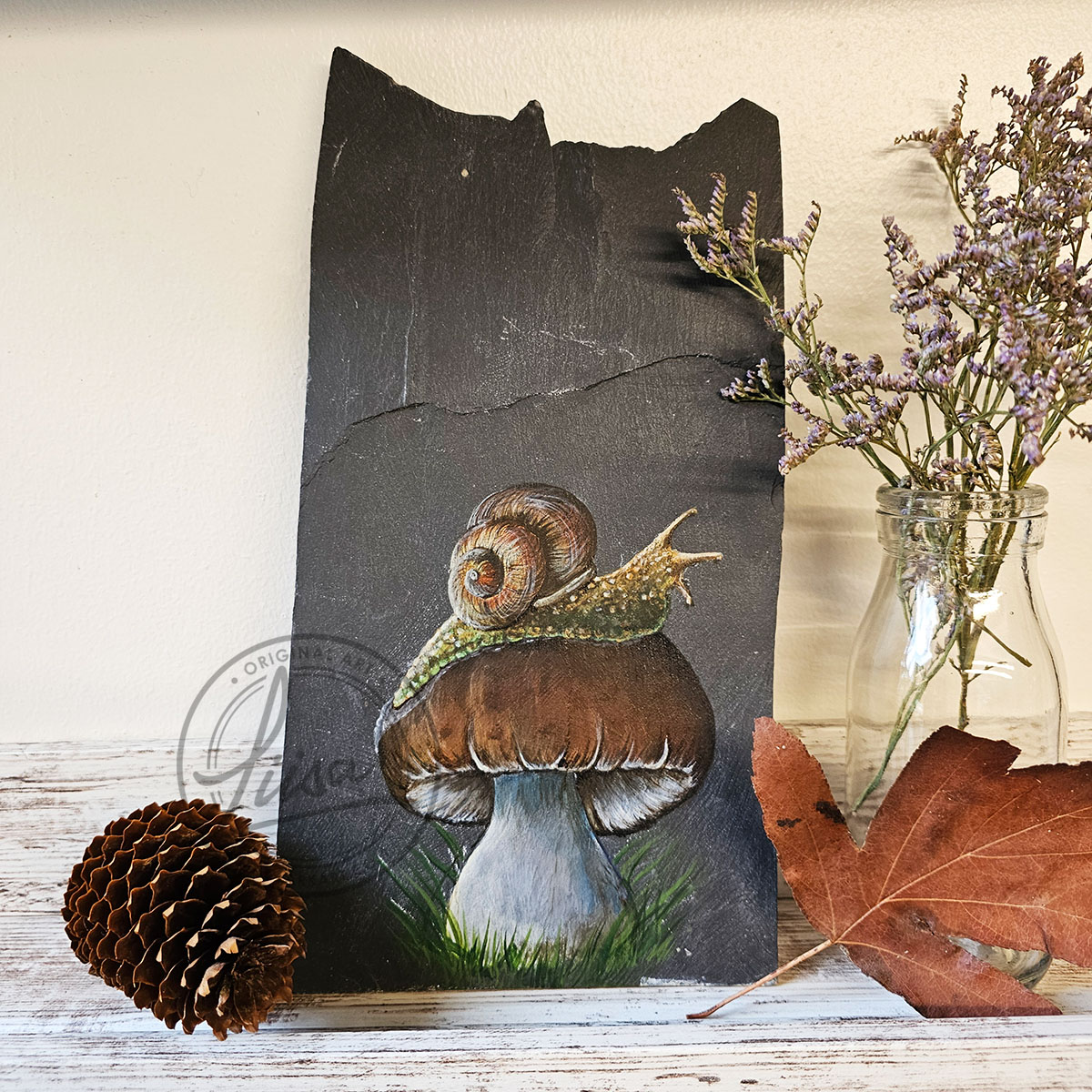 Full front view of the Malwen Madarch Welsh slate painting displayed on a styled shelf with earthy and dark woodland décor.