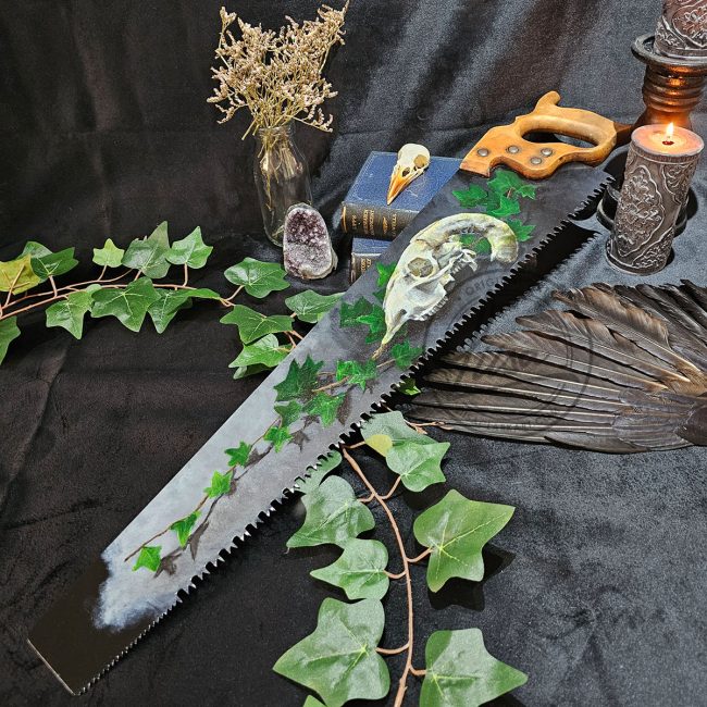 Sheep skull and ivy oil painting on reclaimed antique hand saw by UK wildlife artist Liisa Clark