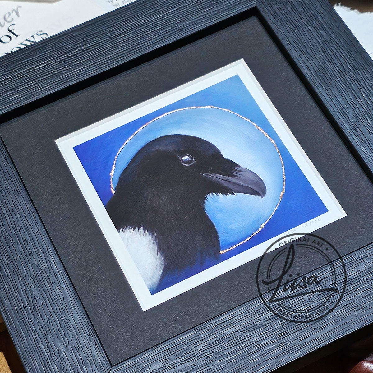 Close-up of hand embellished copper leaf detailing on a framed magpie giclée print from the Blue Corvid Series by Liisa Clark Art.