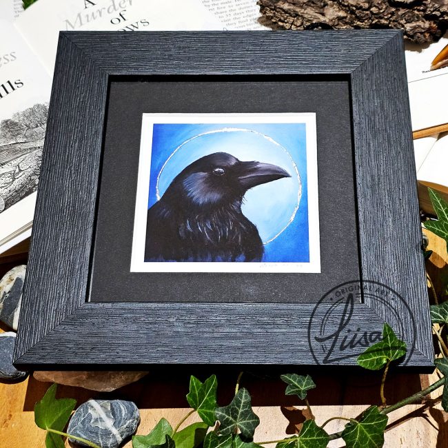 Framed crow artwork with silver leaf embellishment displayed with ivy and natural history objects from the Blue Corvid Series by Liisa Clark Art.