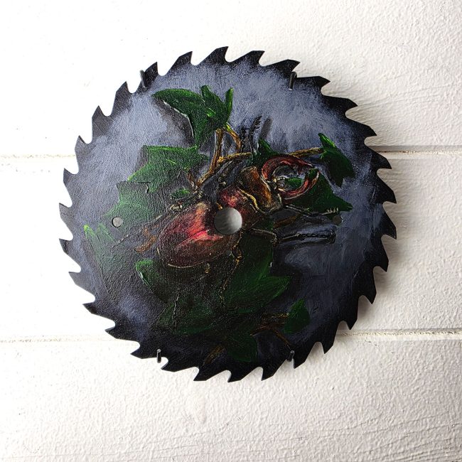 Keeper of the Old Blade original stag beetle painting on a reclaimed circular saw blade by wildlife artist Liisa Clark